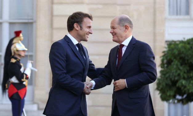 Macron, Scholz plaster over differences with smiles and a handshake