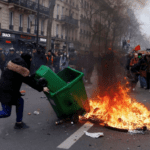 Embattled Macron heads to China, leaving burning Paris behind